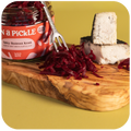 Truffle & Charcoal Cheese and Spicy Beetroot Kraut close up on a fork 